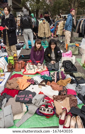 Harajuku, Japan - December 8: Seller sell the second hand clothes at flea market in Yoyogi Park, Harajuku on December 8, 2013. It is the winter flea market in the city of fashion Harajuku, Japan.