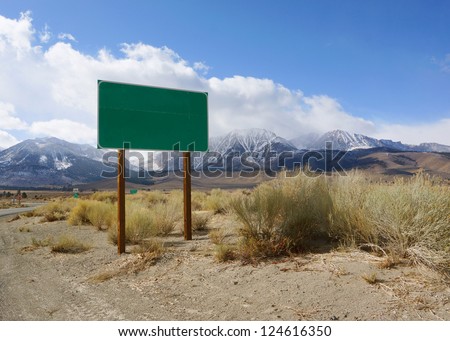 Blank green road sign board in rural area