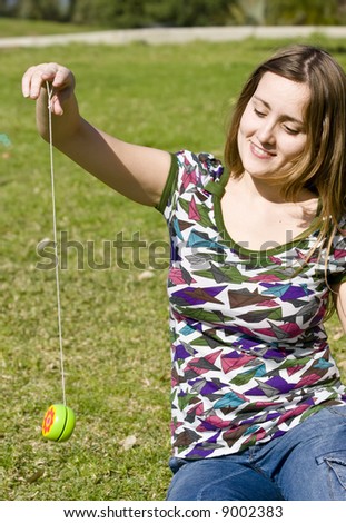 Young woman playing yo-yo in the park