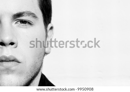 Unshaved handsome man portrait in black and white.