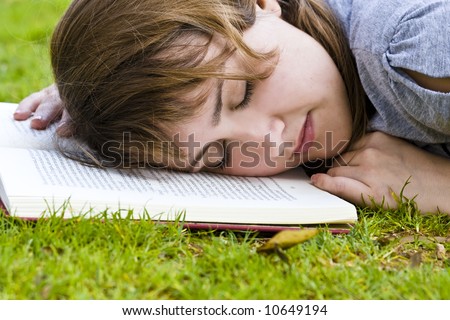 Young blonde taking a nap after reading
