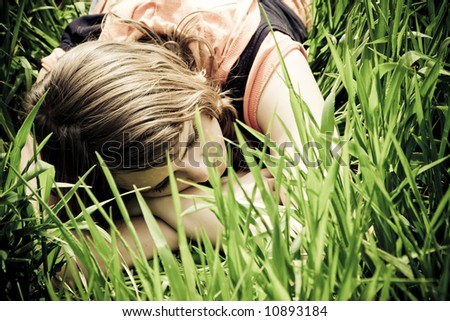 Young slept woman trough the grass