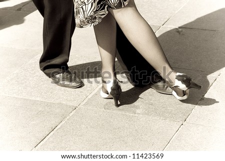 Street dancers performing tango dance. Aged tone. Copy space.