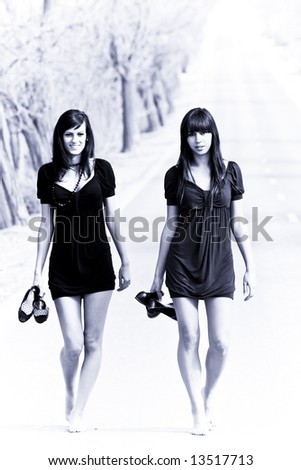 Two couple of young models parading in the middle of the road