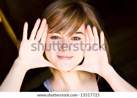 Beautiful blond woman framing herself with her hands