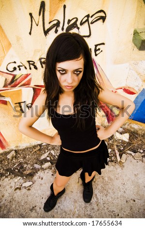 Goth girl posing in urban background.