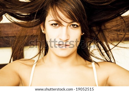Young crazy hair woman sensually staring at camera.