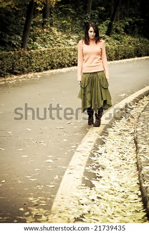 Young woman taking a walk by the road.