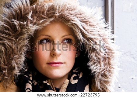 Blond woman portrait wearing a fur cap.