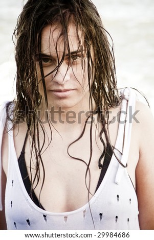 Wet hair woman staring sensually, and creepy, at camera.