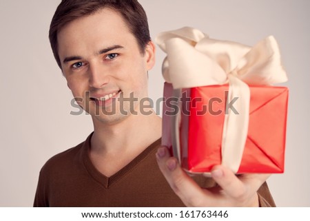 smiling guy offers gift (retro) gift close-up