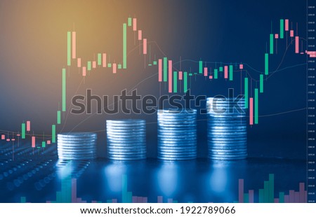 Stack of money coin with trading graph, financial investment concept with blue filter can be use as background Foto d'archivio © 