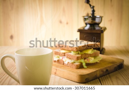 Sandwiches and a cup of tea in wooden