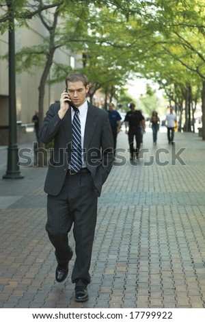 Attractive businessman talking on a cell phone outside, downtown