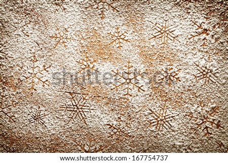 Christmas background with snowflakes. Snowflake pattern made of icing sugar on wooden table. Top view