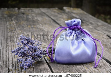 Lavender bag and flower on a wooden background