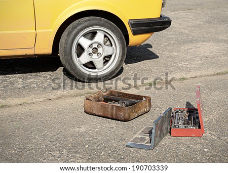 Car tool kit on the asphalt