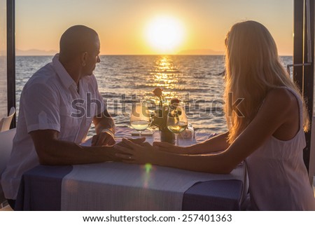 Couple viewing subset in sea restaurant