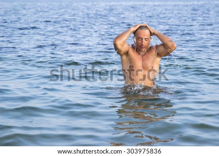 Muscular man in sea water