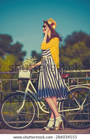 Girl on a bike ride with a retro hipster bike,