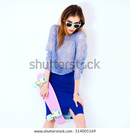 Vogue fashion model woman posing in blue skirt on white studio background