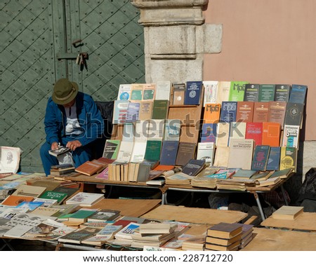 LVIV, UKRAINE - OCTOBER 4, 2014: Book flea market near the monument of Ivan Fyodorov. Man selling his books and looking at second hand book on 4 October 2014, Lviv, Ukraine.