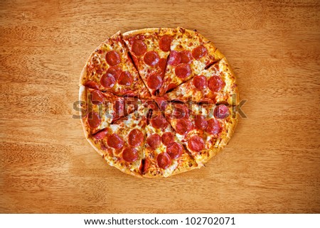 Pepperoni pizza on wood table.