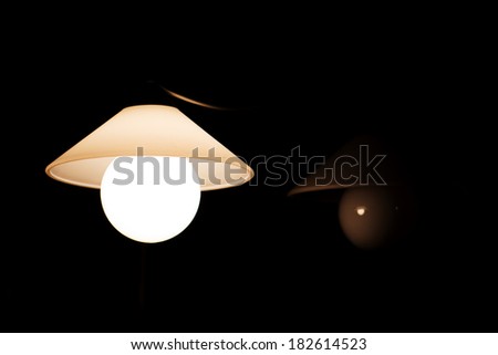 Chandelier with Lamp in the Dark Room. Black Background.