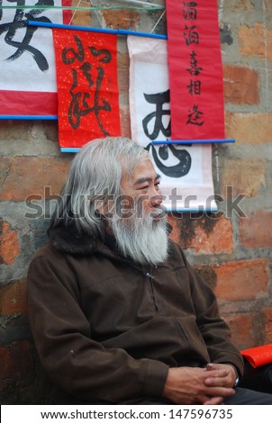HANOI, VIETNAM, FEBRUARY 14: Old master is near ancient letter for everyone in lunar new year on February 14, 2013 in Hanoi, Vietnam. This is a tradition of vietnamese people in lunar new year
