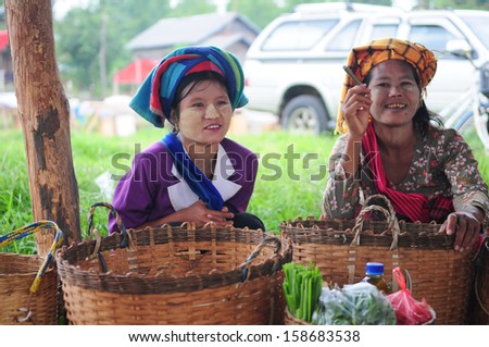 INLE LAKE, MYANMAR, SEPTEMBER 5: Two ethnic minority woman in a traditional market on September 5, 2013 in Inle Lake, Myanmar. There are 8 ethnic minority group in Inle lake area