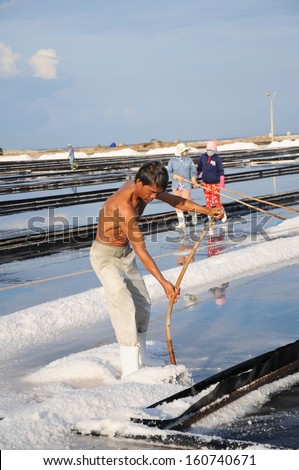 NINHTHUAN, VIETNAM, MAY 03: Unidentified man works in salt field on May 03, 2013 in Ninhthuan, Vietnam. Ninhthuan is central province in Vietnam