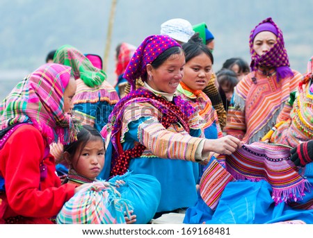 LAOCAI, VIETNAM, DECEMBER 28: H\'mong ethnic minority women buy clothe in Cancau traditional market on December 28, 2013 in Laocai, Vietnam. H\'mong is the 8th largest ethnic group in Vietnam.
