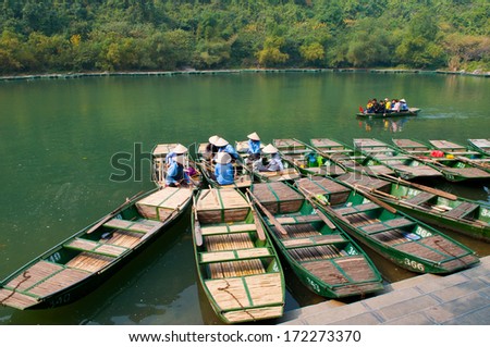NINHBINH, VIETNAM, JANUARY 4: Unidentified boat owners wait for tourists visit Trang An grottoes on January 4, 2014 in Ninhbinh, Vietnam.  Trang An grottoes are famous place in Ninhbinh province