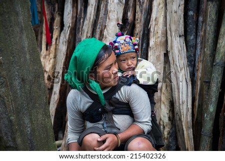 LAOCAI, VIETNAM, AUGUST 31: HaNhi ethnic minority woman with her child on MAY 31, 2014 in Laocai, Vietnam. There are many ethnic minority groups in Laocai