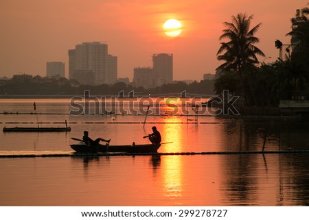 HANOI, VIETNAM, July 8, 2015. Boat in sunset in West Lake (Ho Tay) in Hanoi. West Lake is a biggest lake in Hanoi, Vietnam.