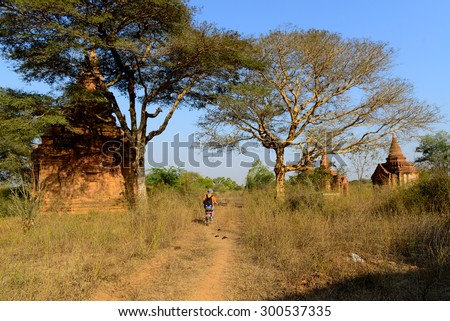 BAGAN, MYANMAR - FEB 25, 2015 : Tourist visit temples by electric motor cycle in Bagan. Bagan is ancient city with thousands of ancient temples in Myanmar.