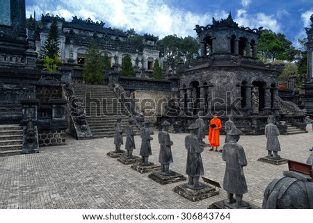 HUE, VIETNAM, MAY 3: A monk is among stone statues in Khai Dinh royal tomb on May 3, 2014 in Hue, Vietnam. Hue, a UNESCO World Heritage site.