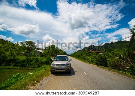 LANGSON, VIETNAM, AUGUST 2, 2014: A car on the road to Bac Son town . Bac Son is a town of Lang Son province, North Vietnam.