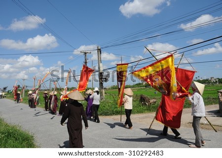 THAIBINH, VIETNAM, JUL 31, 2014: People in a funeral ceremony in a countryside. The surviving family, relatives take part in the funeral procession to accompany the dead to the burial ground