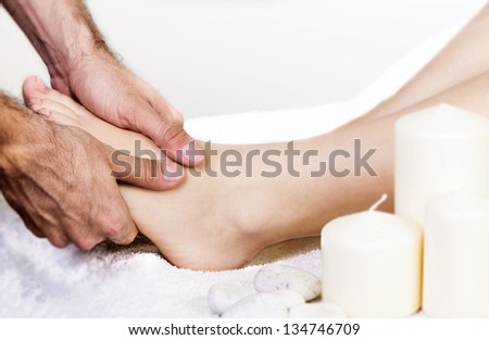 Physiotherapist giving a foot massage with his fingers