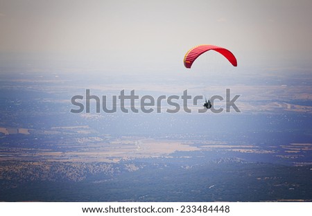 Paragliding, flying over El Escorial in Madrid, Spain.