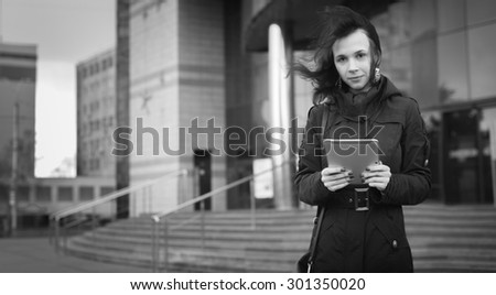 Black and White. BW. Young woman with Tablet reading from ebook