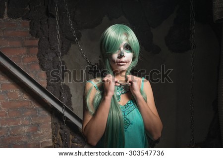 Halloween portrait of young woman with sugar skull makeup