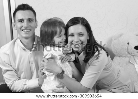 Black and White. BW. Family portrait with mother father and daughter