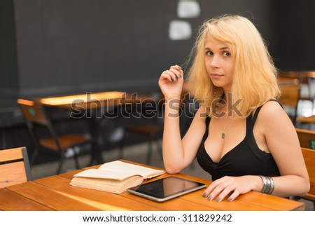 Image of young beautiful woman in summer park reading a book