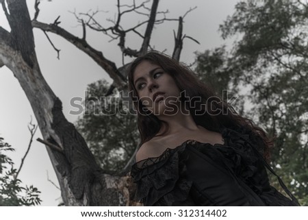 Wicked dangerous goth girl in the autumnal field