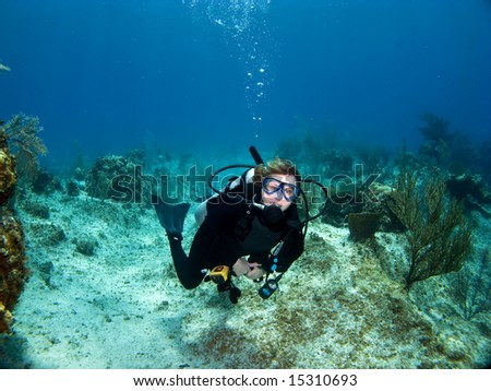 Female Scuba Diver swimming while looking at the Camera