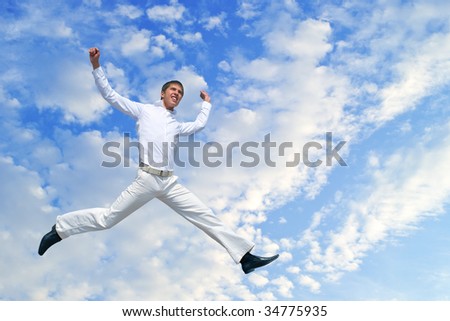 Young happy men jumping against blue sky with clouds
