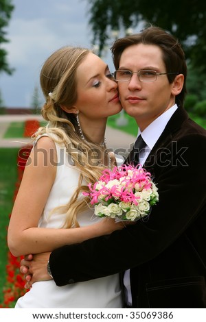 portrait of the bride and groom against summer landscape