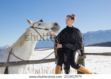 Young Woman With White Horse In Winter